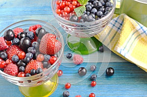 Berries of red-blue color on a blue background healthy food