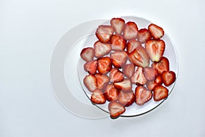 Berries of ripe and delicious strawberries on a white plate