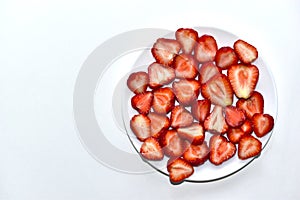 Berries of ripe and delicious strawberries on a white plate