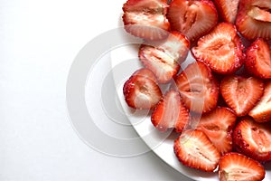 Berries of ripe and delicious strawberries on a white plate
