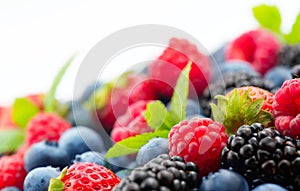 Berries. Various colorful berries background. Mint leaves, Strawberry, Raspberry, Blackberry, Blueberry close-up backdrop