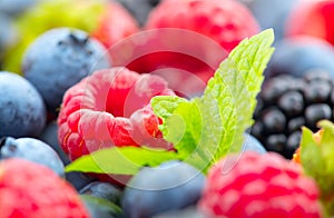 Berries. Various colorful berries background. Mint leaves, Strawberry, Raspberry, Blackberry, Blueberry close-up backdrop