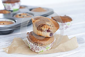 Berry chocolate muffins in an iron baking dish closeup