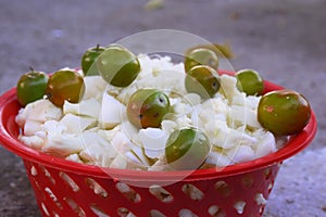 Berry and chopped cauliflower kept in a red colored basket used for vegetable and salad