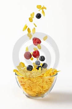 Berry fruit falling in corn flakes