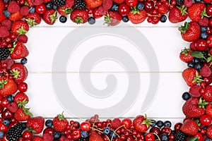 Berry fruits frame with strawberries, blueberries, cherries and