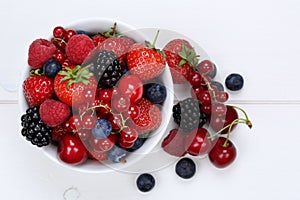 Berry fruits mix in bowl with strawberries, blueberries and cherries from above photo