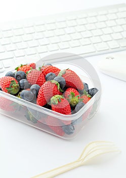 Berry mix lunch on working desk in office
