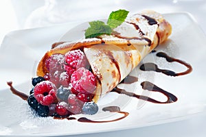 Berry pancake drizzled with chocolate