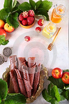 Berry pastille made of strawberries and apples on a white background. Honey and Chia seeds on a light background. Health food.