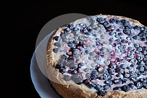 Berry pie cake from the cherries currants in a bowl of fresh steam a whole and slices of hot background blurred