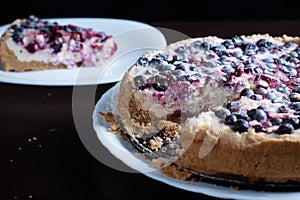 Berry pie cake from the cherries currants in a bowl of fresh steam a whole and slices of hot background blurred
