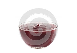 Berry sauce in a glass bowl close-up on a white background