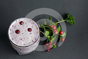 Berry smoothie. Milkshake with fresh lingonberries on a dark background. Healthy food, detox or diet concept. Copy space