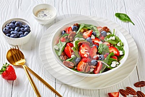 Berry spinach salad with nuts and crumbled feta