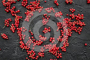 Berry theme. Red currant on black table background top view