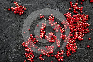 Berry theme. Red currant on black table background top view