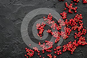 Berry theme. Red currant on black table background top view copyspace