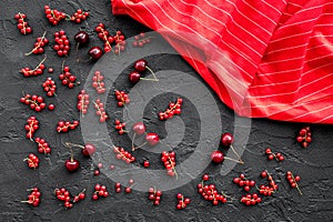 Berry theme. Red currant and cherry on black table background top view mockup