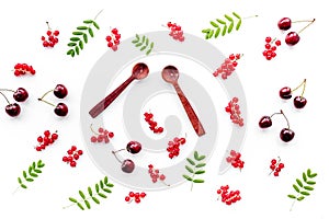 Berry theme. Red currant, cherry, wooden spoons and leaves on white background top view