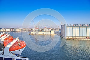 Berth cargo port with cranes on the background of the morning sky