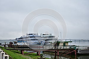 Berth on the river cruise ships embankment, bridge automobile, fog over