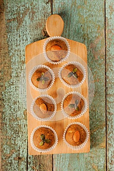 Besan laddu with pumpkin seeds and almond in paper cups