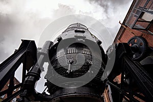 Bessemer converter steel and iron foundry equipment Sheffield bulk metal production. stormy cloud and large black gears