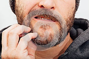 Best ager man scratching beard photo