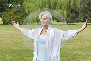 Best ager women practising yoga ant tai chi