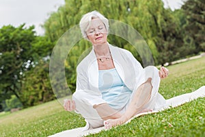 Best ager women practising yoga ant tai chi