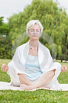 Best ager women practising yoga ant tai chi