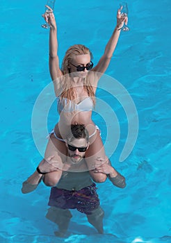 Best Beaches in the World. Beach scene people. Man giving piggyback ride to girlfriend on beach. Bali. Beautiful young