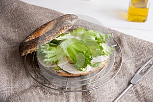 Bagel with chicken roll, green salad and cream cheese