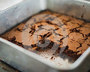 Best brownies dessert in a cake pan. High angle view of freshly baked brownies. Delicious chocolate cake