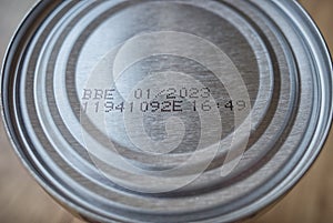 Best before date stamped onto base of tin can. Close up.