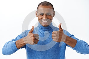 Best deal online. Portrait of confident african american man assuring its good, show thumbs-up as recommend, approve or