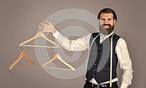 Best design. portrait of man holding hanger. tailor man use tape measure. professional male sartor with measuring tape