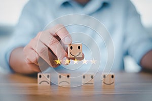 Best excellent business services rating customer experience. Satisfaction survey concept. Hand of a businessman chooses a smiley f