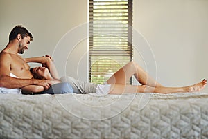 This is the best feeling in the world. a happy young couple relaxing in bed together.