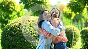 Best female friends hugging outdoors, happy to see each other, sisters relations