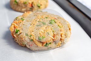 Best fish cakes raw uncooked on  baking tray. . Close up of crab patties photo