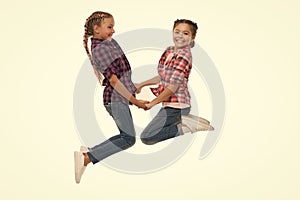 Best friend dressing. Girls friends wear similar outfits have same hairstyle kanekalon braids white background. Sisters