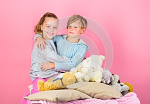 Best friends brother and sister. Kids siblings friends hug pink background. Children friends near teddy bear soft toys