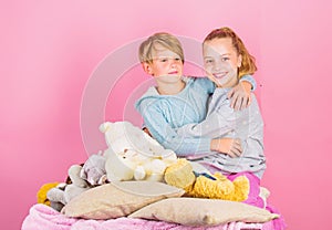 Best friends brother and sister. Kids siblings friends hug pink background. Children friends near teddy bear soft toys