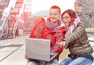 Best friends with computer laptop looking surprised