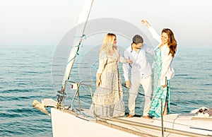 Best friends dancing and having fun on exclusive luxury sailing boat - Friendship travel concept with young people millenial