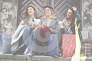 Best friends enjoying after shopping. Young girls sitting