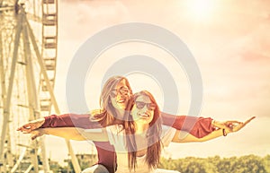 Best friends enjoying time together outdoors at ferris wheel