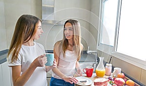 Best friends girls teens breakfast in kitchen